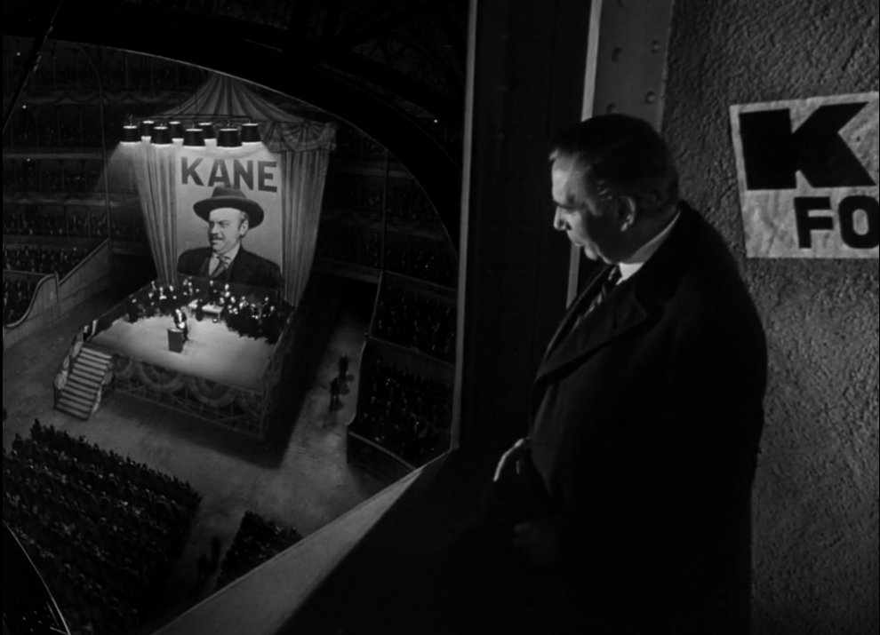 Jim W. Gettys watches Charles Foster Kane give a speech to a crowd of people