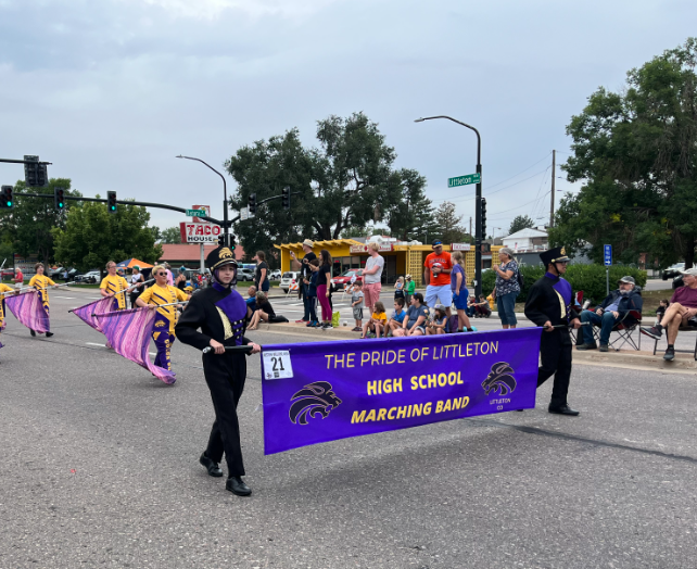 Marching band and colorguard members perform for the crowd